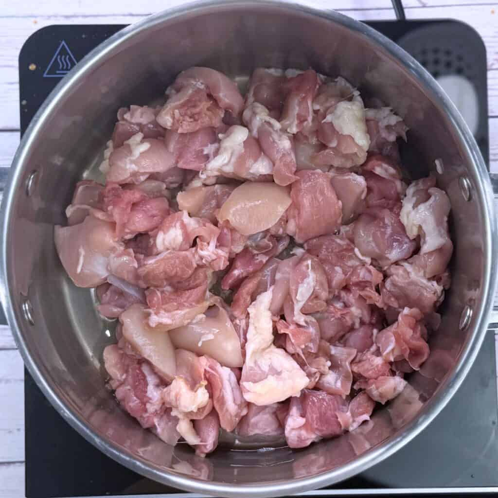 Raw chicken in pot