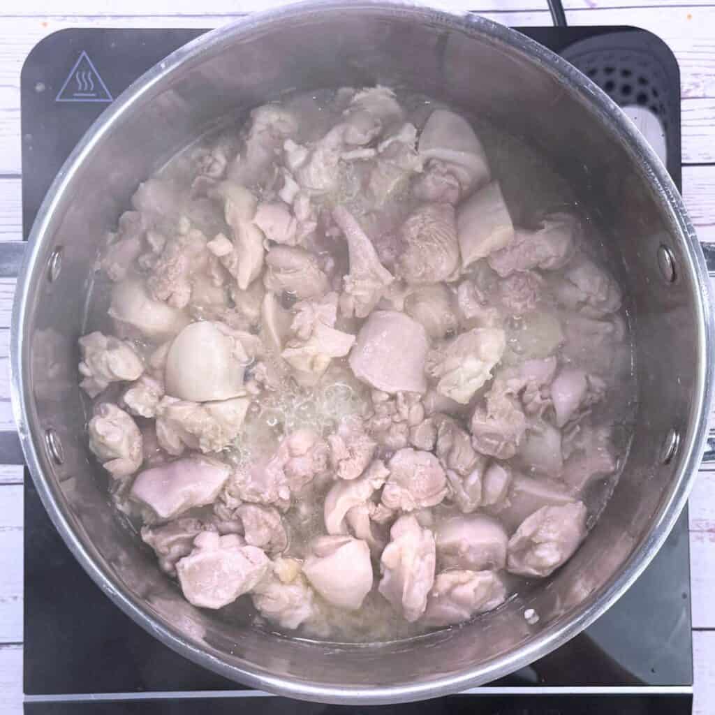 Cooked chicken thigh in pot