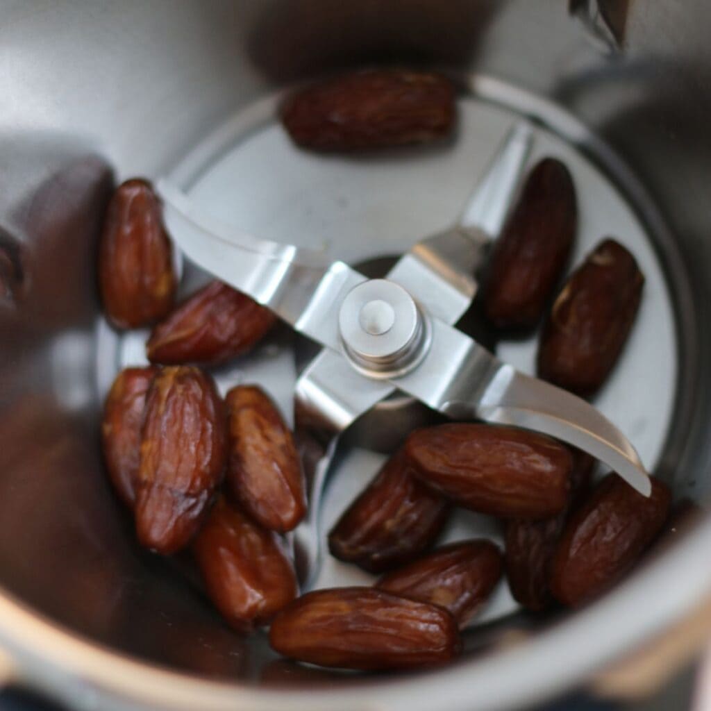 Fresh Medjool dates in bowl of a food processor
